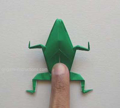 using finger on rear of body to make origami frog jump